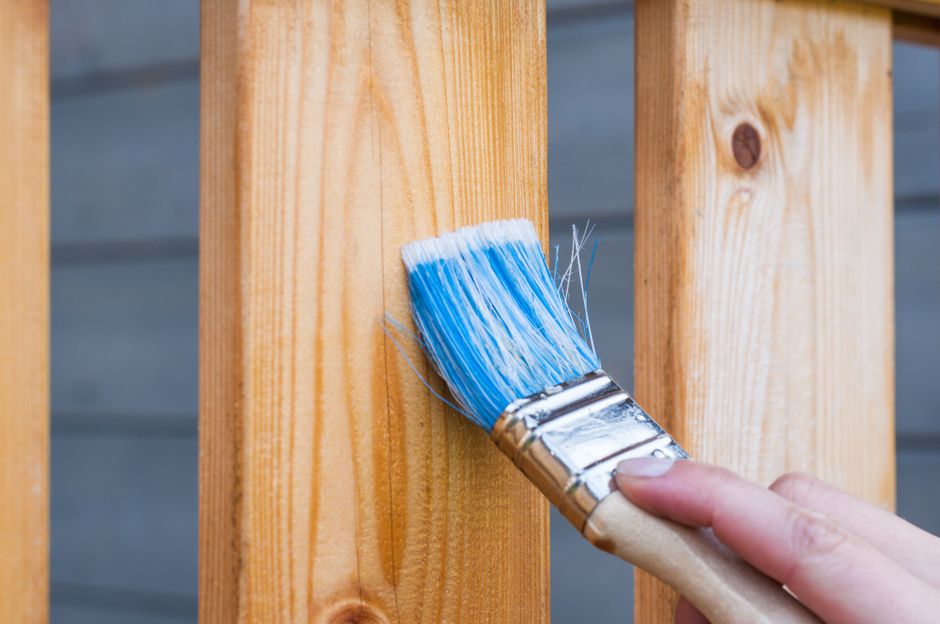 Brush work on a stained cedar fence
